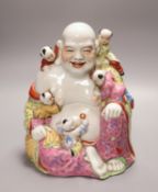 A Chinese famille rose figure of Budai, mid 20th century, 26cm
