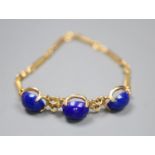 A modern 750 yellow metal and three stone cabochon lapis lazuli set ring and bar link bracelet,