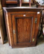 A George III oak hanging corner cabinet, width 74cm, depth 42cm, height 92cm