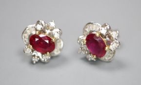 A modern pair of white metal (stamped 750), ruby and diamond cluster ear studs, 10mm, gross 2.3