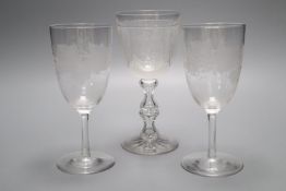 A wheel engraved glass goblet and two similar wine glasses, tallest 29cm