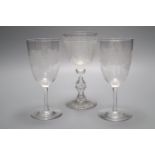 A wheel engraved glass goblet and two similar wine glasses, tallest 29cm