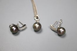 A modern 18k white metal, cultured Tahitian? pearl and diamond set pendant, 27mm and pair of