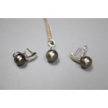 A modern 18k white metal, cultured Tahitian? pearl and diamond set pendant, 27mm and pair of