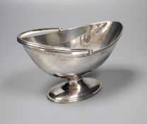 A Victorian oval silver swing-handled sugar basket, having thread edge, Sheffield, 1888, height 10.