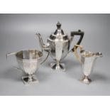 An Edwardian engraved silver three piece pedestal coffee set by James Deakin & Sons, Sheffield,