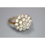 A modern 9ct gold and cubic zirconia cluster set dress ring, size J, gross 2.3 grams.