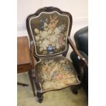 A Victorian rosewood scroll armchair