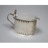 A George III pierced silver oval mustard pot, maker, W?, London, 1785, with blue glass liner and