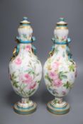 A pair of Minton style ovoid vases and covers, decorated with roses, 37cm