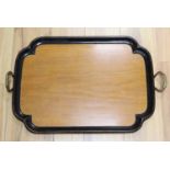 An Edwardian walnut and ebonised framed two handled tea tray, width 65cm