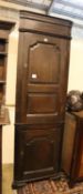 A 17th century style oak corner cupboard, width 58cm, depth 30cm, height 190cm