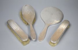A 1920's engine turned silver mounted four piece mirror and brush set by Elkington & Co, Birmingham,