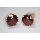 A pair of yellow metal and garnet set earstuds, gross 1.9 grams(a.f.).