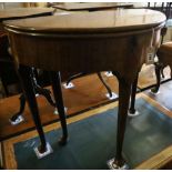 A George II mahogany and fruitwood games table, with hinged top and raised on pole and pad supports,