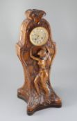 An unusual French Art Nouveau walnut mantel clock, carved in relief with a wood nymph dancing