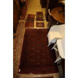 A Bokhara rug, 184 x 125cm together with a mat and three saddlebags