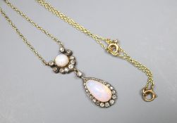 An Edwardian yellow and white metal, two stone white opal and diamond cluster set drop pendant