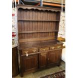 A George III style oak dresser, width 138cm, depth 45cm, height 190cm