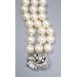 A triple strand cultured pearl bracelet, with diamond set white metal clasp, 17.5cm, gross 38.7