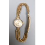 A lady's 1960's 9ct gold Omega manual wind wrist watch, on multi strand bracelet with expanding
