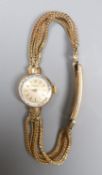 A lady's 1960's 9ct gold Omega manual wind wrist watch, on multi strand bracelet with expanding