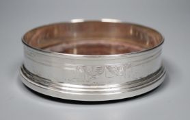 A circular silver wine coaster with engraved decoration, Birmingham 1980, base 12.6cm.