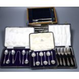 Six silver cake forks, six silver coffee spoons and six silver 'apostle' teaspoons (all cased) and