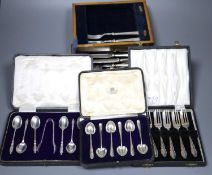 Six silver cake forks, six silver coffee spoons and six silver 'apostle' teaspoons (all cased) and