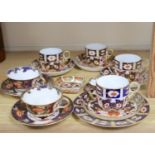 A collection of six Royal Crown Derby cups and saucers, a small square trinket dish and a