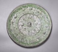 A bronze Chinese squirrel and grape pattern mirror, Tang dynasty or later, diameter 24cm