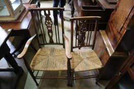 A set of six early 20th century beech ladder back dining chairs (two with arms)
