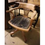 An early 20th century oak tub framed desk chair