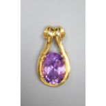 A modern yellow metal and oval cut amethyst set pendant, 31mm, gross 9 grams.