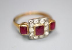 An early 20th century yellow metal, ruby and diamond cluster ring with ruby set shoulders, size K,