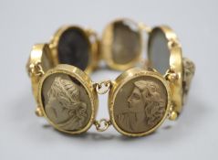 A Victorian gilt metal and lava bracelet, set with seven oval panels carved with busts of ladies and