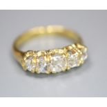 An 18ct and graduated five stone old cut diamond set child's ring, size E/F, gross 2.5 grams.