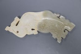 A Chinese archaistic pale celadon and calcified jade plaque