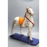 A pre-war papier mache pull-along horse