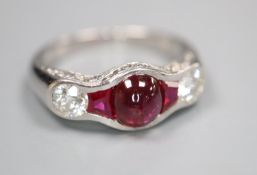 A modern white metal (possibly platinum?), synthetic? ruby and diamond dress ring, set with cabochon