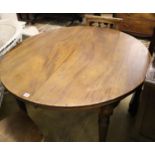 An early 20th century mahogany circular extending dining table, 180cm extended (two spare leaves)