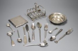 An early 20th century silver toastrack, a silver bowl, silver cigarette case and minor flatware