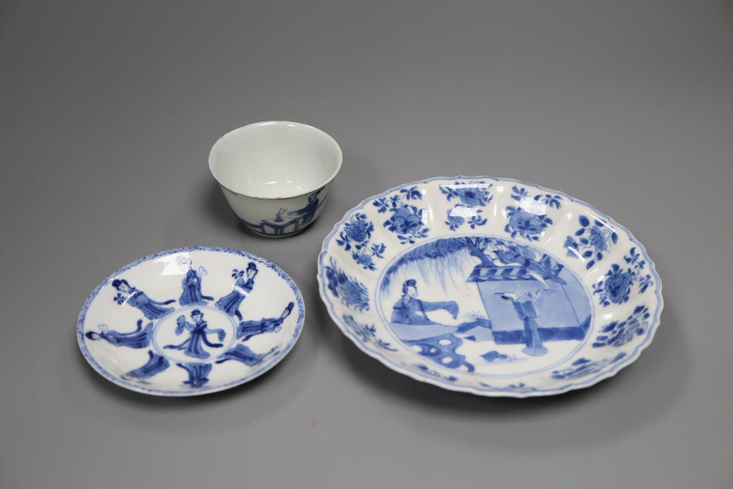 A Chinese Kangxi blue and white saucer dish and a similar tea bowl and saucer