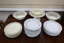 A collection of white glazed basket weave and other dessert ware