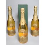 A bottle 1985 Cuvee Dom Perignon in presentation box and three bottles of 1990 Champagne Brut