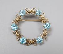 A modern 9ct gold and blue zircon set openwork circular brooch, 30mm, gross 5.7 grams.