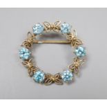 A modern 9ct gold and blue zircon set openwork circular brooch, 30mm, gross 5.7 grams.