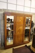 An Edwardian satinwood banded and inlaid mahogany triple wardrobe with fitted interior, width 175cm,