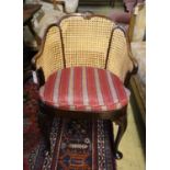 A 1920's Georgian style mahogany bergere with caned sides and cabriole legs