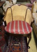 A 1920's Georgian style mahogany bergere with caned sides and cabriole legs